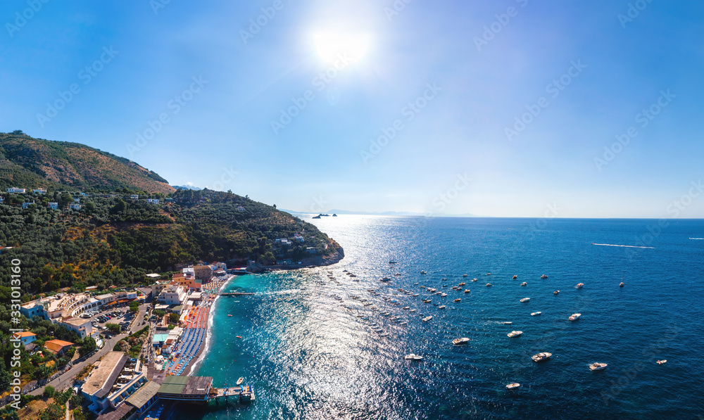 Aerial wide panorama view of coastline of the village of Nerano. Private and wild beaches. Blue surface of the water. Vacation and travel concept. Boats in bay. Copy space. For print wallpapers