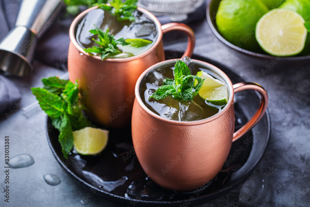 Classic Moscow mule cocktail with lime, mint and ice Classic Moscow mule cocktail with lime, mint and ice