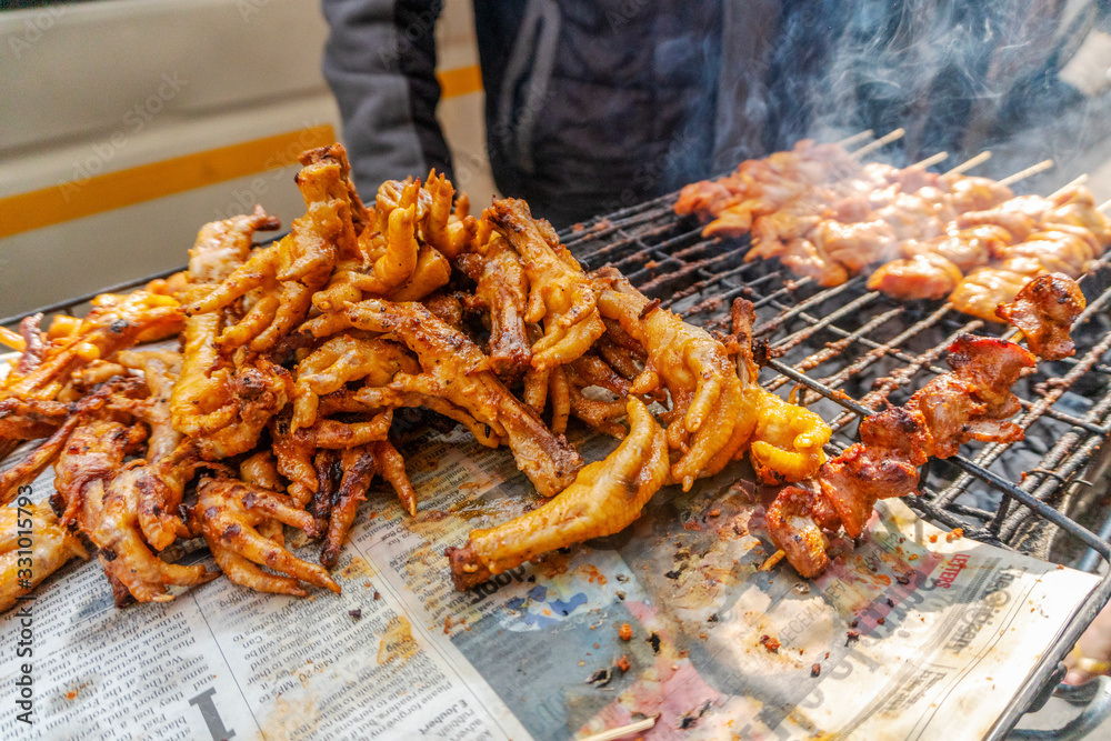 Fototapeta premium South African street food - barbecued chicken skewers and feet