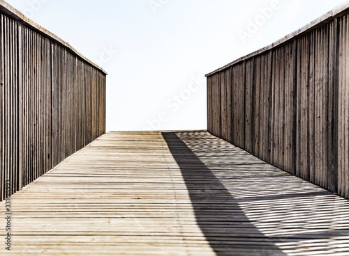 An old wooden bridge leading to nowhere. Concept of alone sadness walk to emptiness.