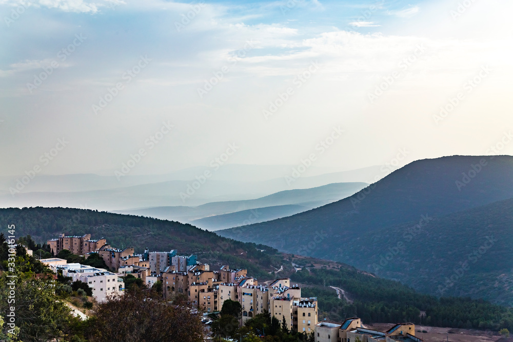 View of Galilee mountains from the Holy city of Safed or Tsfat Israel in the evening. Mountain hills in fog.