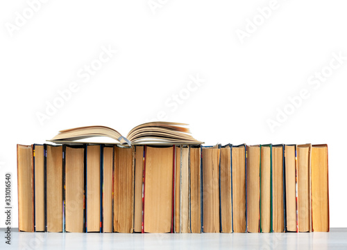 Stack of books and open book isolated on a white background, back to school education concept.