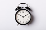 Black vintage alarm clock on white background. Time concept