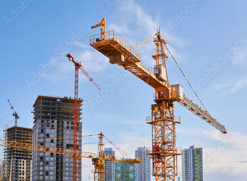 Obraz na plátne construction tower cranes on a building site against the sky