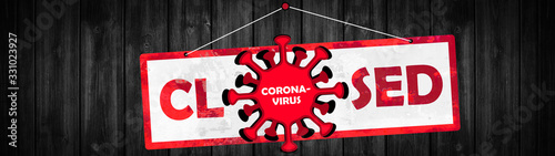 CORONAVIRUS background panorama - " CLOSED " sign banner stamp with sleepy cartoon virus hangs on a rustic black wooden wall, with copy space