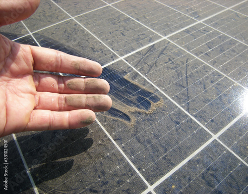 Dirty Hand after Rubbing Dusty Solar Panel