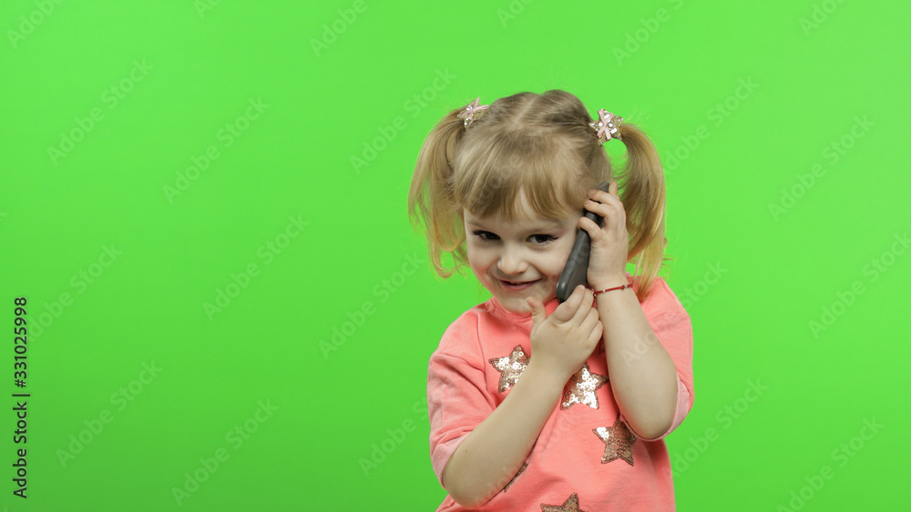 Little girl using smartphone. Child emotionally talking on on mobile phone Little girl using smartphone. Child emotionally talking on on mobile phone