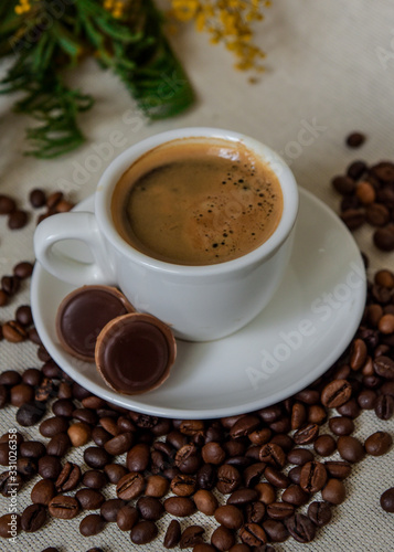 A cup of fresh espresso with chocolates. Coffee beans. Morning coffee concept © Євген Малюга