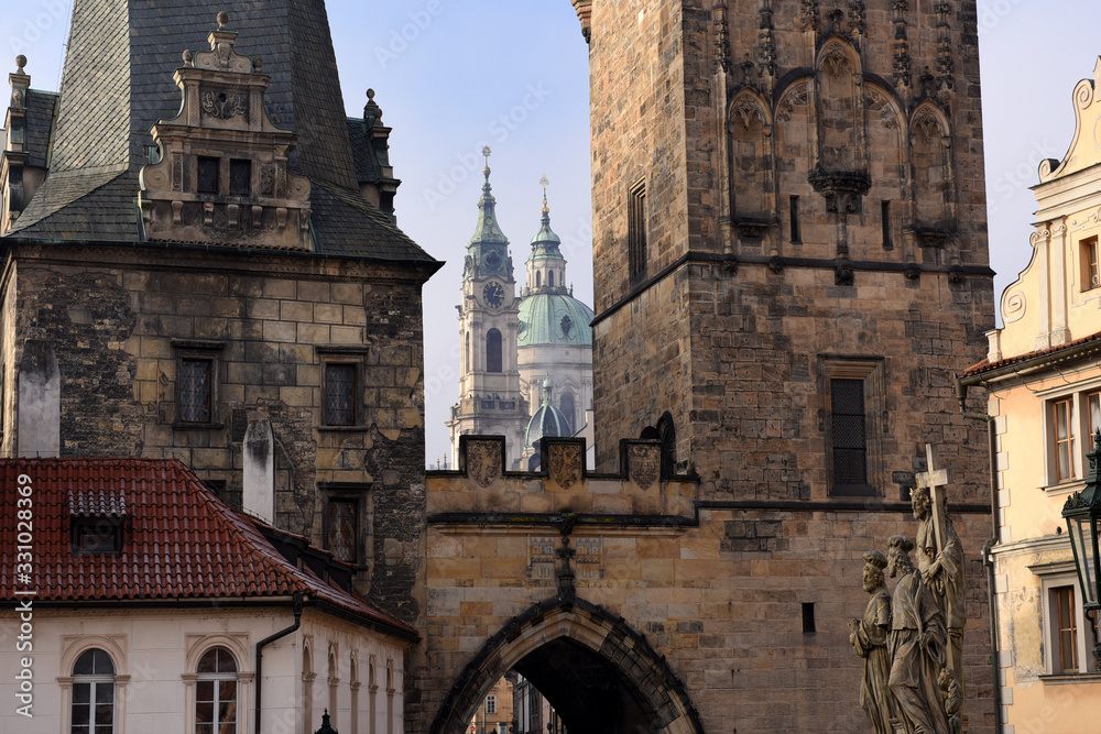 view from the Charles Bridge landmark looking towards Lesser Town with the bridgetower in the foreground and St. Nicholas church in the background, Prague, Czech Republic
