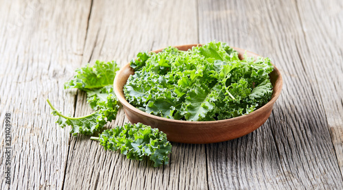 Kale salad on wooden background