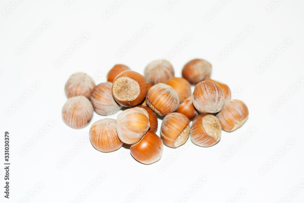 Close up view of shelled Hazelnuts isolated on white. Heap of Hazelnuts as background. Macro view of shelled Hazelnuts.