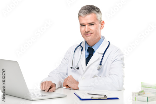 Successful confident doctor seated at a desk