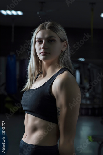 Portrait of a blonde girl with in the fitness gym.
