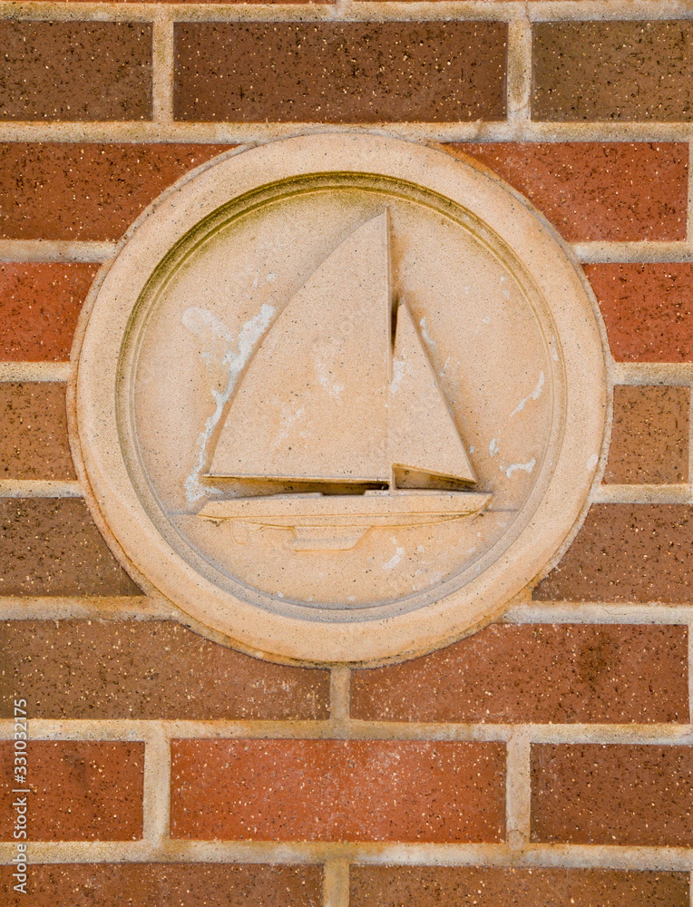 a close up of a boat sculputure in a brick wall