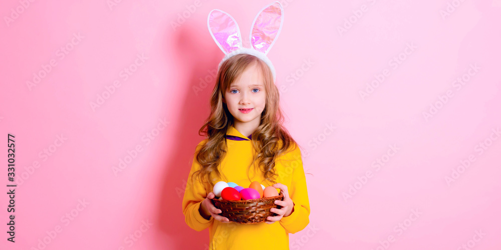 Banner happy Easter! Little girl having fun to paint Easter eggs.