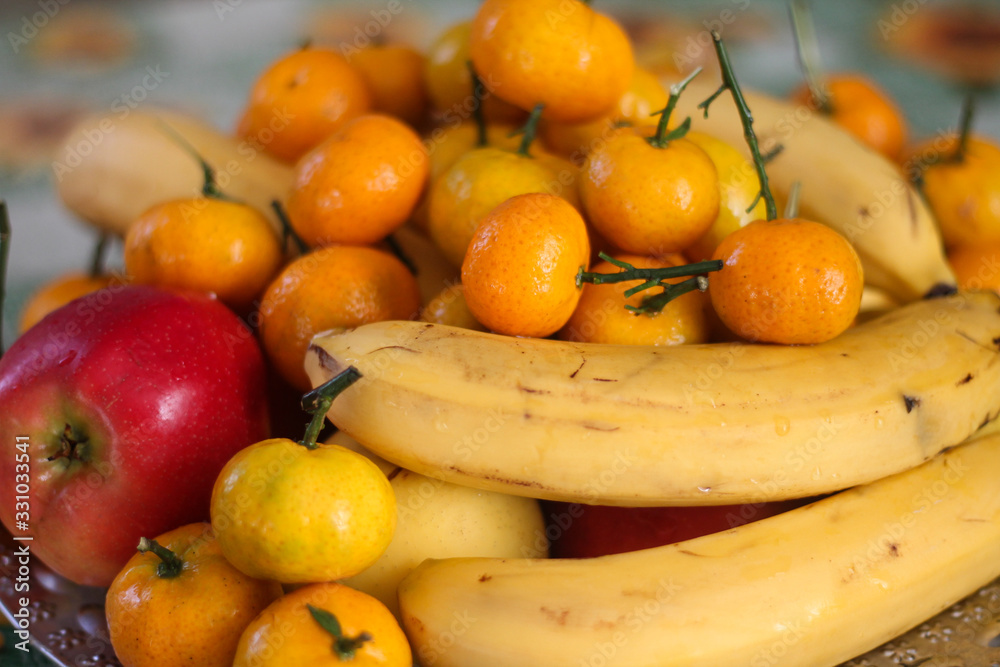 Fruit plate: tangerines, bananas, apples