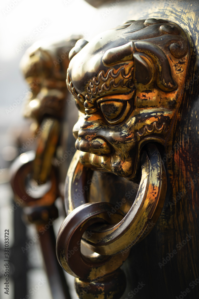 Obraz premium Close-up of a bronze handle of a ancient large bronze water tank, Forbidden City, Beijing China