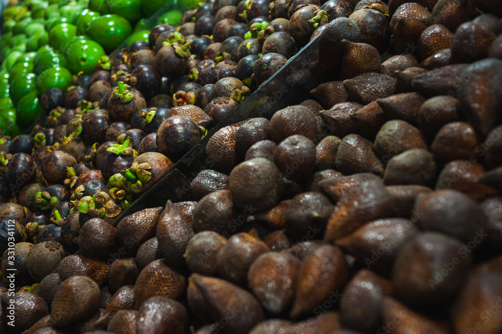 Plenty of fresh Salak fruits on a counter in a market Plenty of fresh Salak fruits on a counter in a market