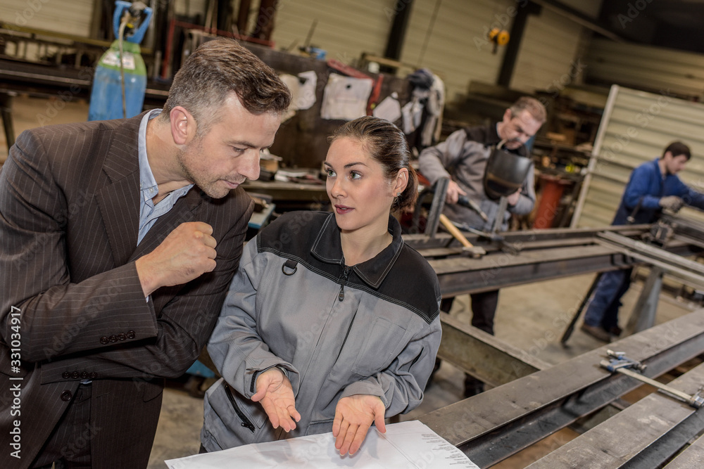 Female factory worker is sure and confident about her job Female factory worker is sure and confident about her job