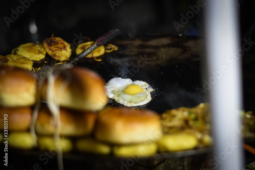 man selling a egg in Indian street food market in nainital 