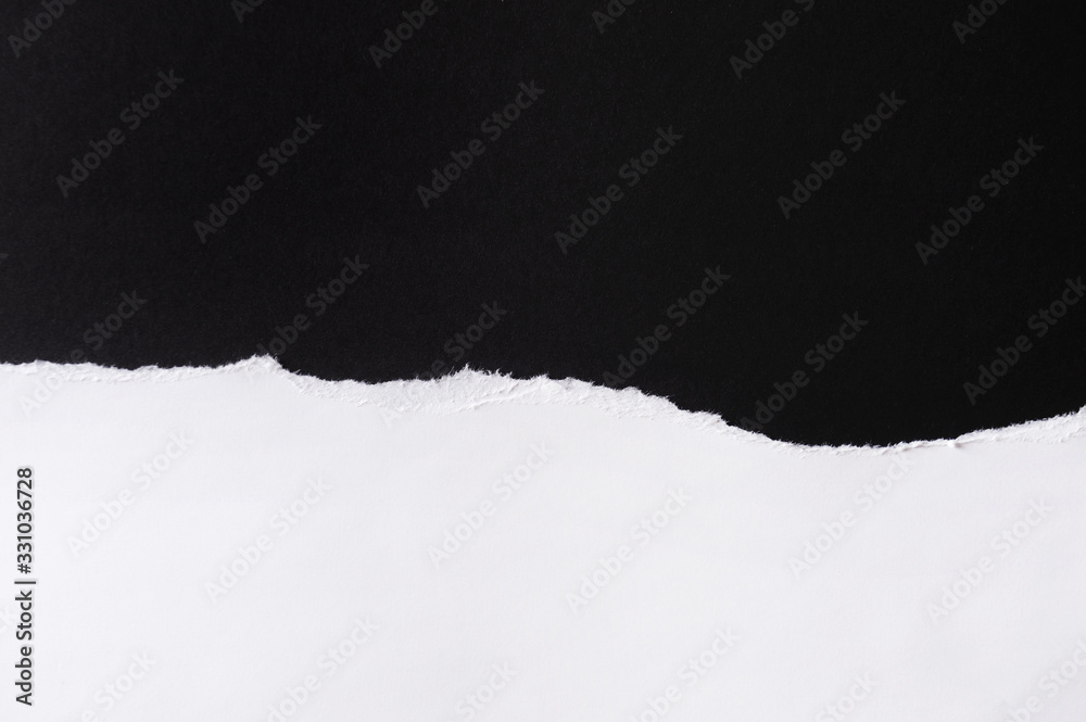 White paper with torn edges isolated with black colored paper background inside. Good paper texture White paper with torn edges isolated with black colored paper background inside. Good paper texture