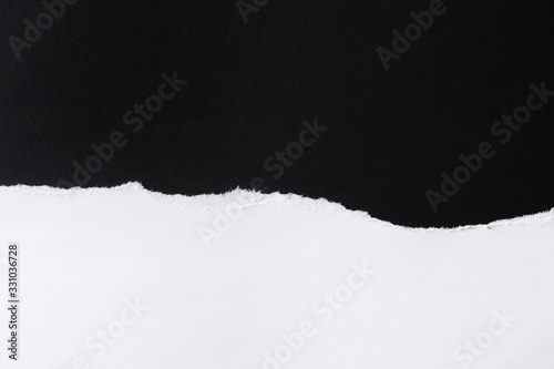 White paper with torn edges isolated with black colored paper background inside. Good paper texture © lial88