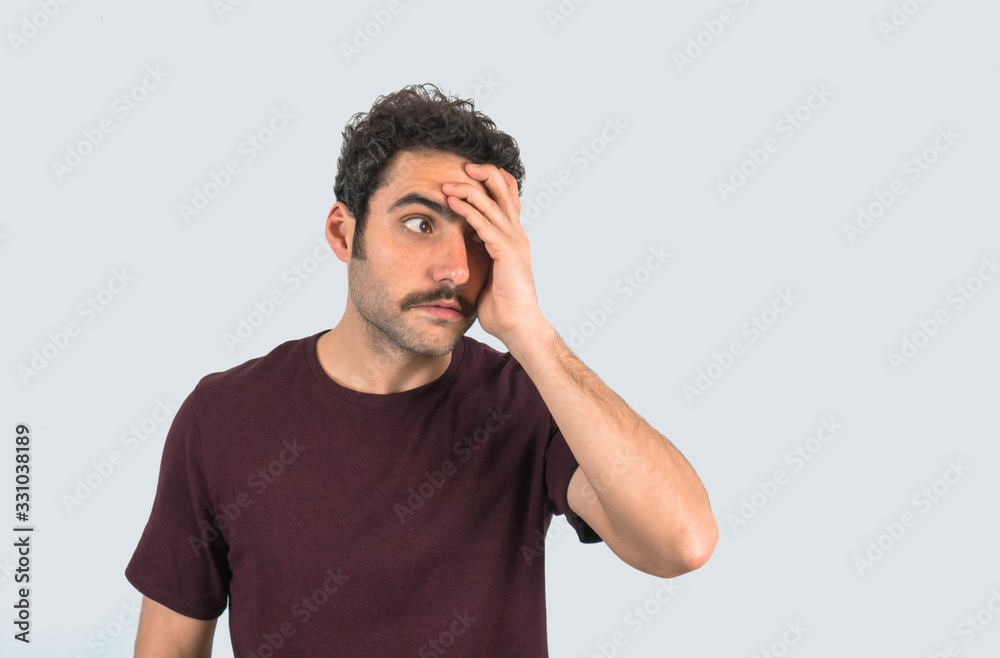 Φωτογραφία Portrait of a young man with a mustache with hand on face with gesture of restlessness
