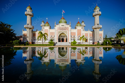 Beautiful Pattani Central Mosque and reflection in water recognized as a special tourist attraction.southern, Thailand.(Translate Thai and Arab text in image is name of the central mosque of Pattani)