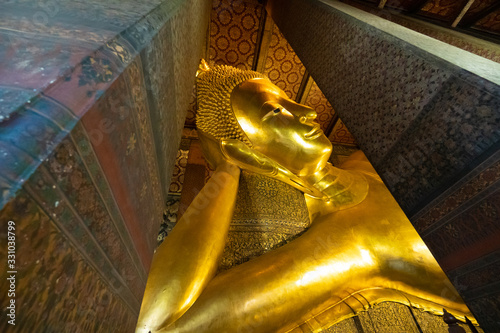 Reclining buddha in Wat Pho in Bangkok photo