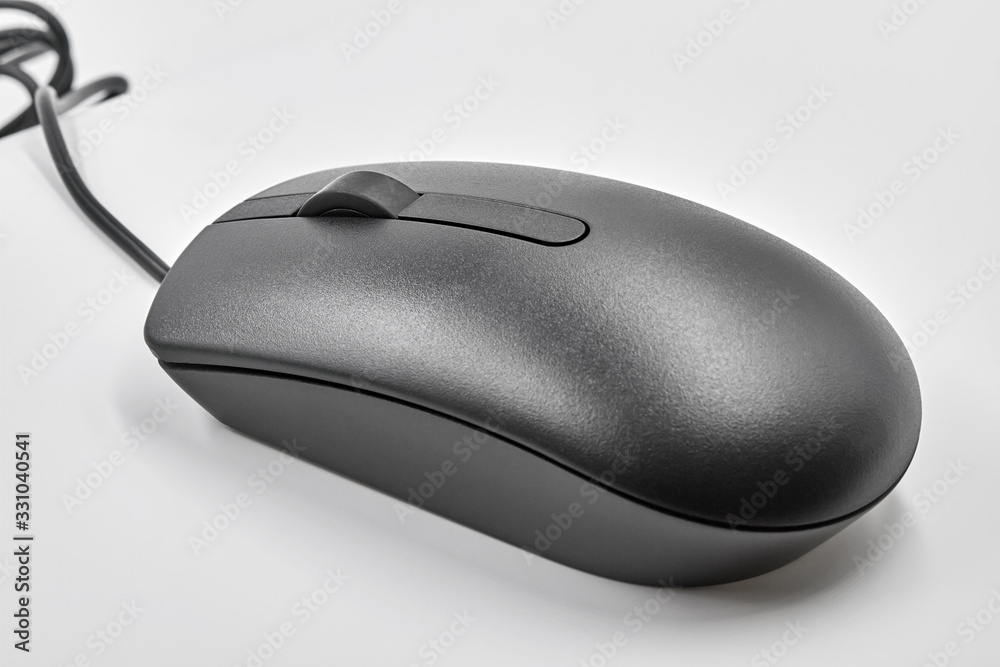 Black optical computer mouse with usb cable on white background. Closeup Black optical computer mouse with usb cable on white background. Closeup