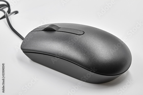 Black optical computer mouse with usb cable on white background. Closeup