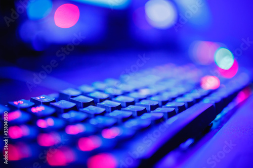 Keyboard and mouse for professional streamer video gamers with computer. Cyber sport championship, neon blue color lights