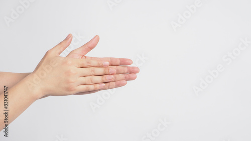Male model is rubbing hand plams together on white background.