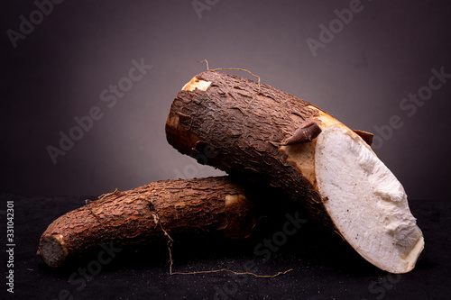 Εκτύπωση καμβά Two edible unprepared Cassava roots with bark still in place