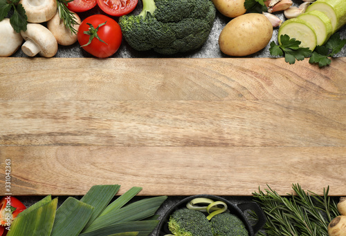 Fresh products and wooden board with space for text, flat lay. Healthy cooking