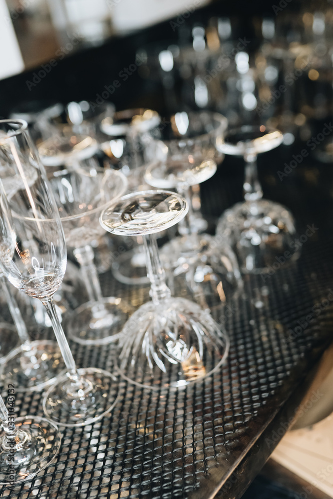 Many clean wineglasses in bar, professional equipment