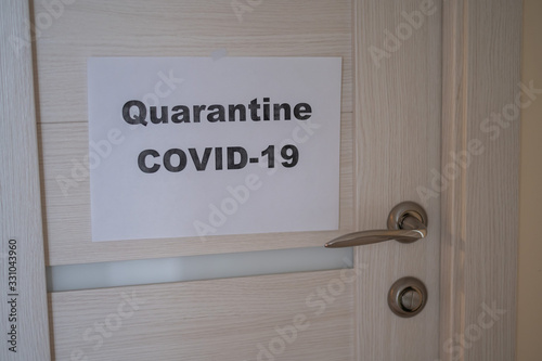 Fototapeta Naklejka Na Ścianę i Meble -  Ad on the door. Quarantined. Coronavirus epidemic. Pandemic of the 21st century. covid-19