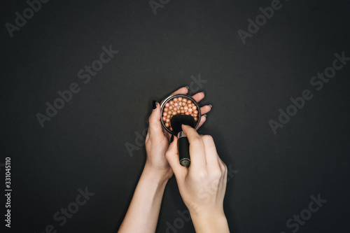 Many professional cosmetics for make up on black background 