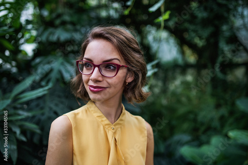 Young woman standing in botanical garden. Copy space. © Halfpoint