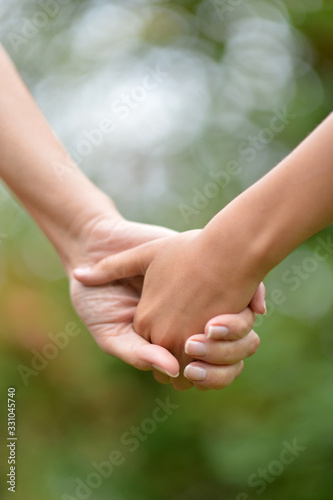 Daughter and mother holding hands close up © aletia2011