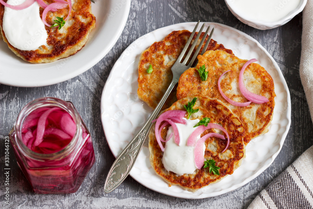 Breakfast made from traditional boxty fritters or latkes served with pickled onions and sour cream. Breakfast made from traditional boxty fritters or latkes served with pickled onions and sour cream.
