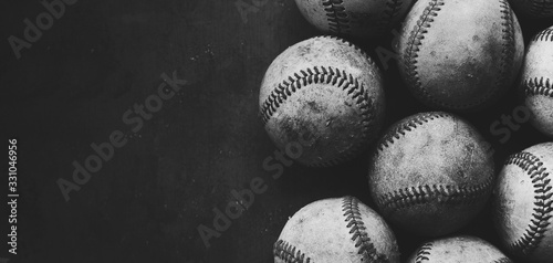 baseball background with old grunge used balls close up in black and white with copy space. photo