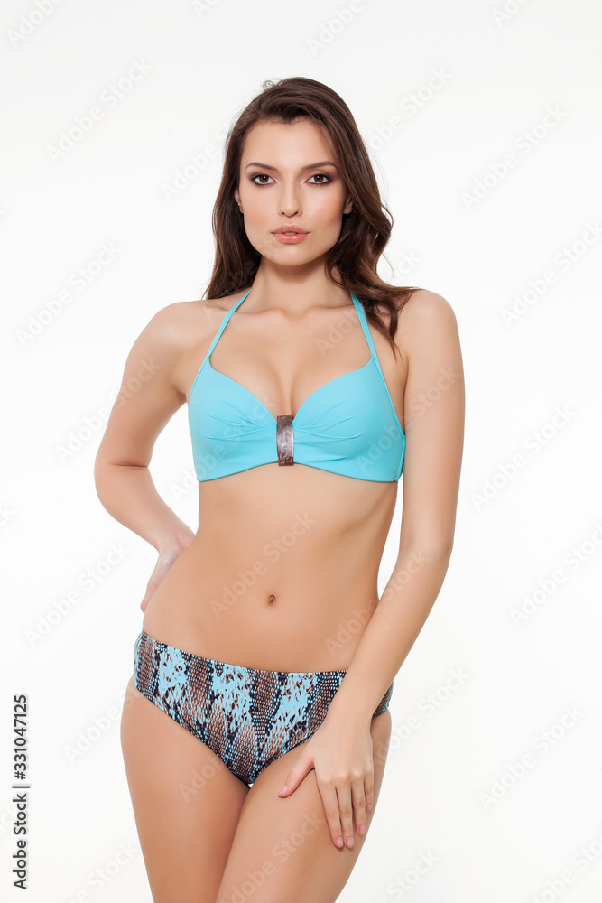 beautiful girl posing in stylish detailed chic light blue bikini on white background. beautiful girl posing in stylish detailed chic light blue bikini on white background.