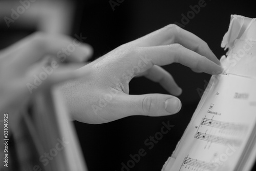 Hand turning page of sheet music