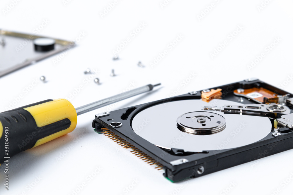 Disassembled hard drive from the computer on white background. Hdd pc repair service concept. Disassembled hard drive from the computer on white background. Hdd pc repair service concept.