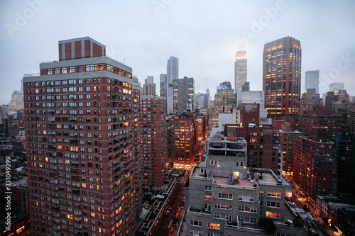 New York city skyline with foggy sky, night lights and traffic