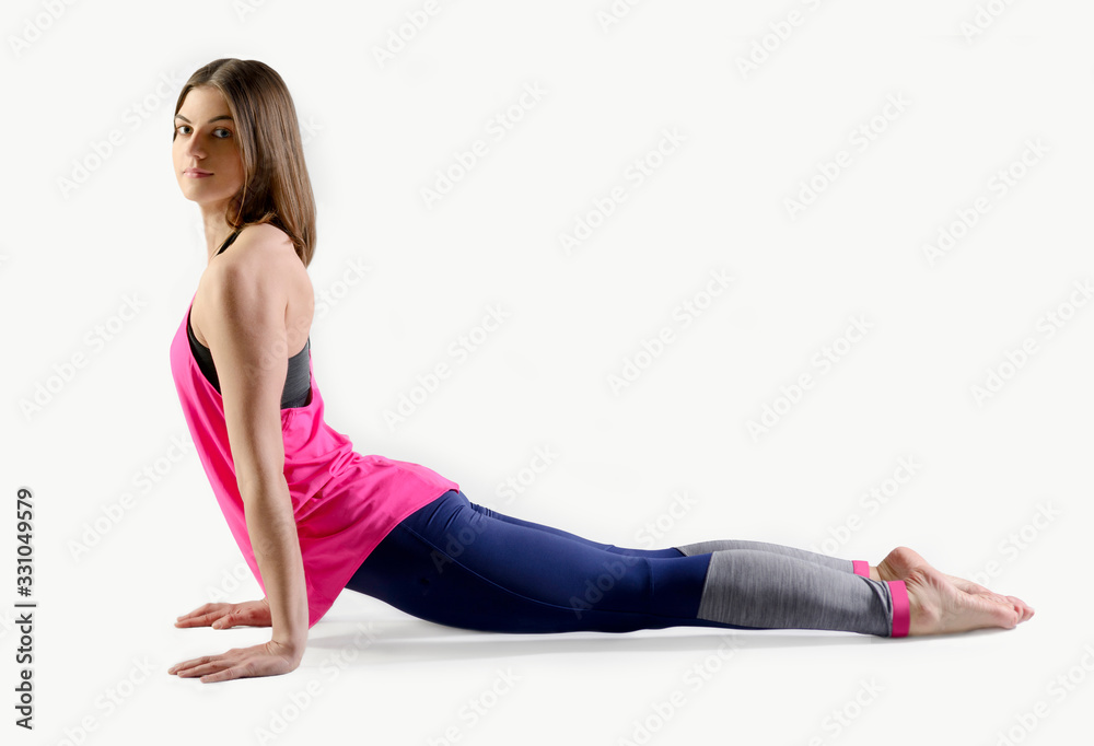 Young pretty woman doing yoga pose on grey isolated background Young pretty woman doing yoga pose on grey isolated background