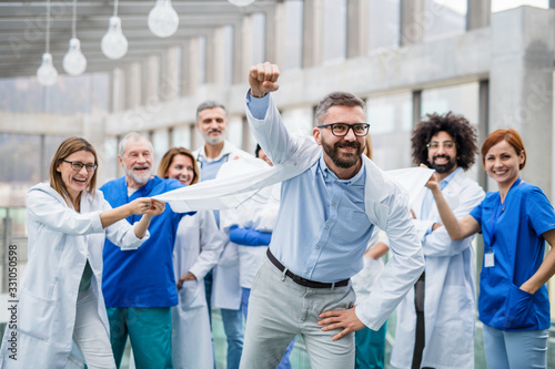 Schilderij op canvas Group of doctors standing in corridor on medical conference, having fun