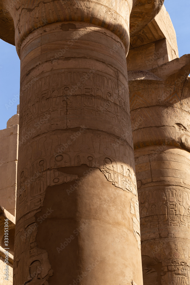 Karnak Temple, complex of Amun-Re. Great Hypostyle Hall. Embossed hieroglyphics on columns. Luxor Governorate, Egypt.