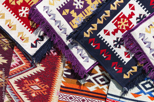 Assortment of small Caucasian and Oriental carpets © evannovostro